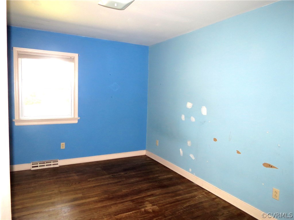 10810 Surry Road Chester, VA 23831 - Photo 19 of 24 a view of an empty room with wooden floor and a window