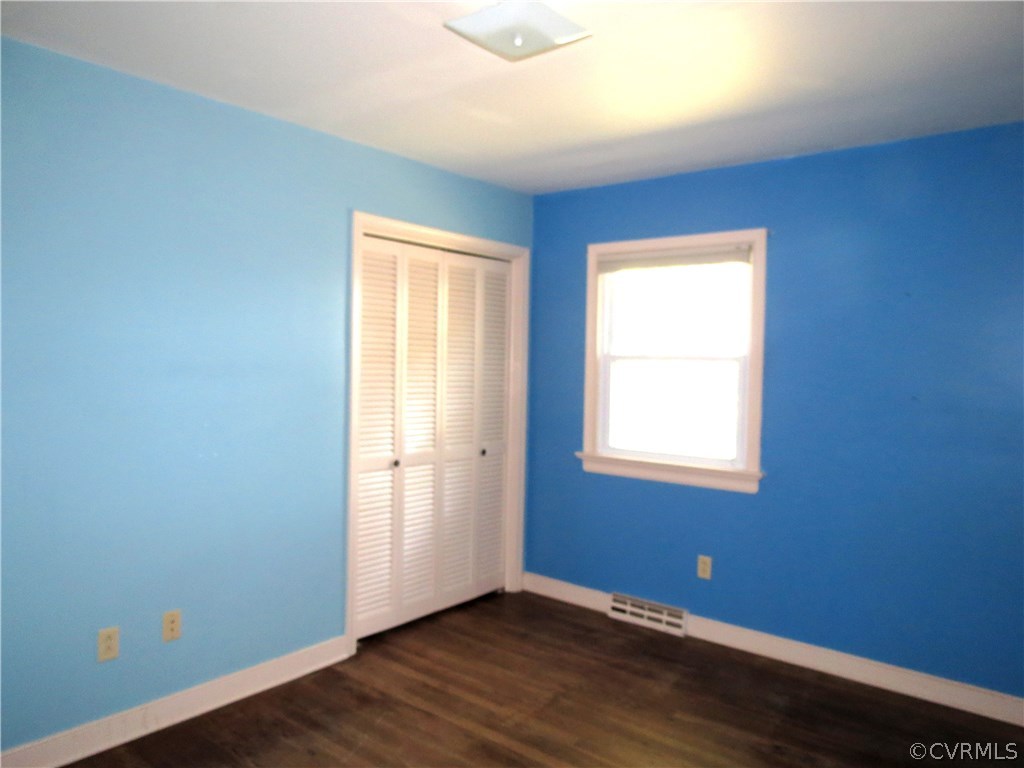10810 Surry Road Chester, VA 23831 - Photo 20 of 24 an empty room with wooden floor and windows