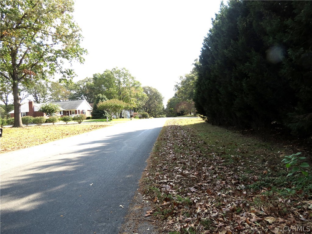 10810 Surry Road Chester, VA 23831 - Photo 23 of 24 a view of a street with a yard and trees