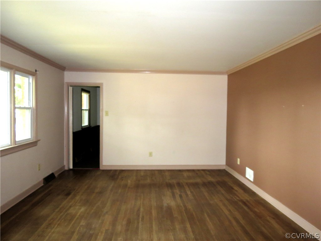 10810 Surry Road Chester, VA 23831 - Photo 5 of 24 an empty room with wooden floor and windows