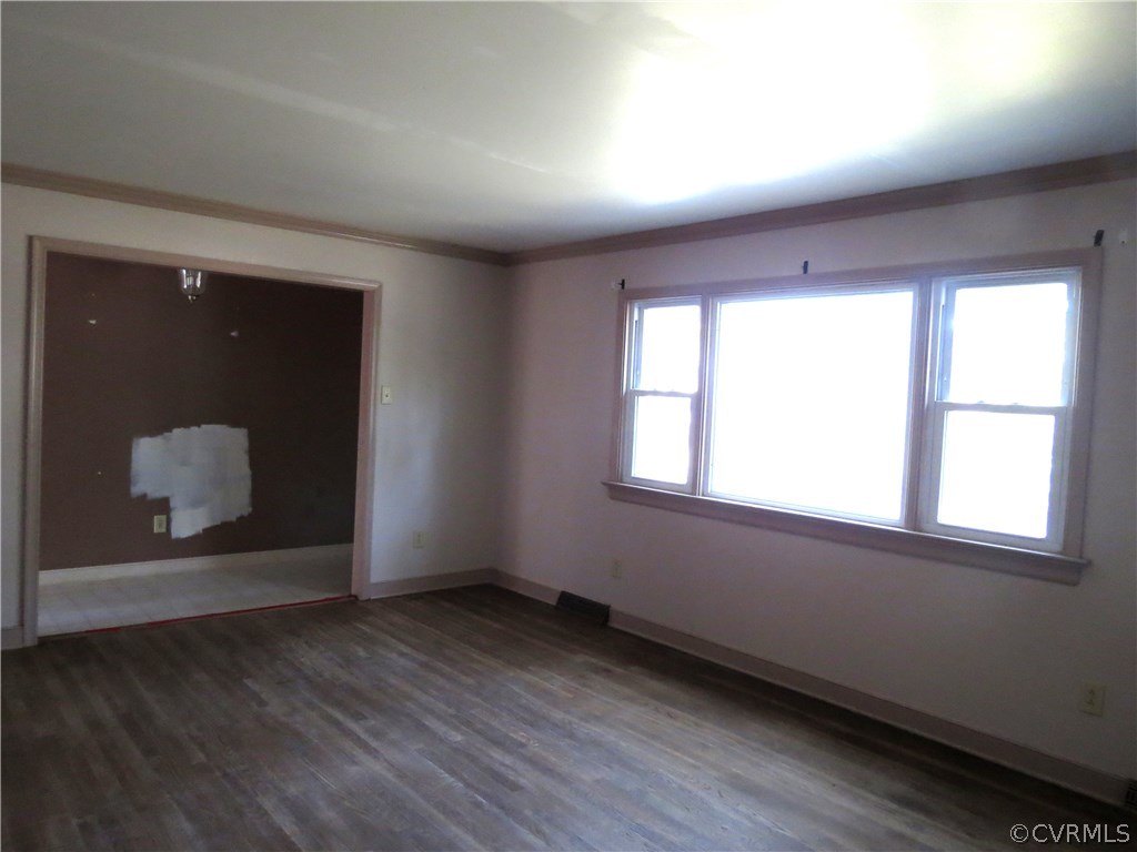 10810 Surry Road Chester, VA 23831 - Photo 7 of 24 an empty room with wooden floor and windows