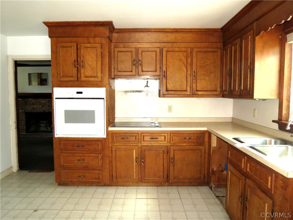 10810 Surry Road Chester, VA 23831 - Photo 10 of 24 a kitchen with stainless steel appliances granite countertop a stove and a sink