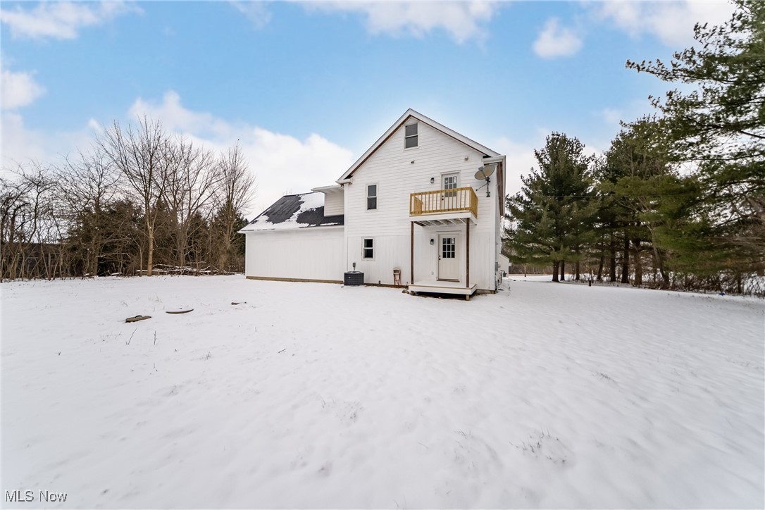 7488 Greenwich Road Seville, OH 44273 - Photo 31 of 37 Snow covered house with a balcony and solar panels