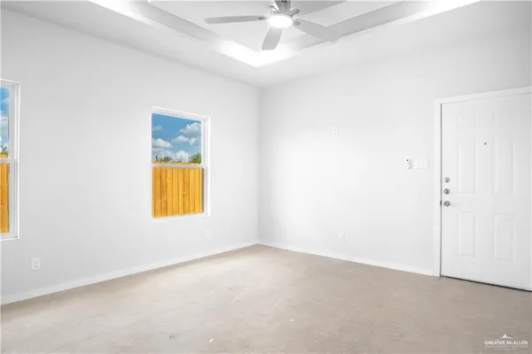an empty room with a window and fireplace
