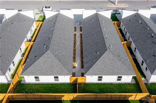 an aerial view of a house with a yard