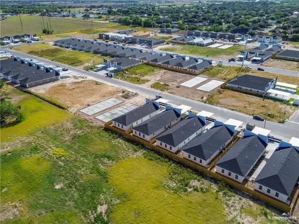 an aerial view of residential houses with swimming pool