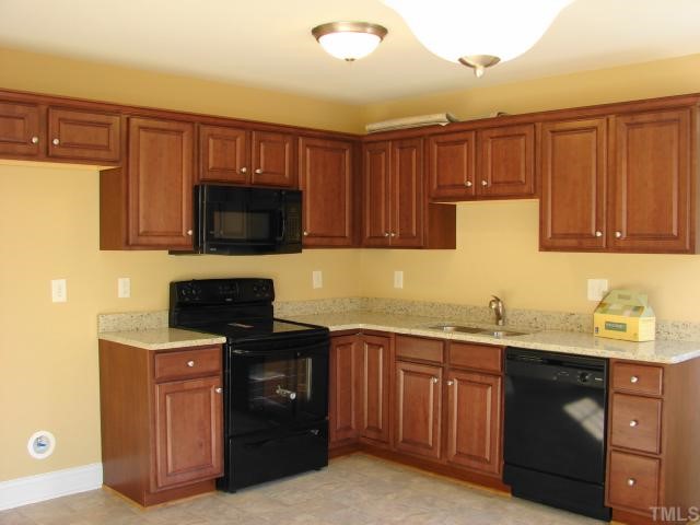 212 Orkney Road, Unit LOT13 Stem, NC 27581 - Photo 4 of 12 a kitchen with a sink stove and microwave