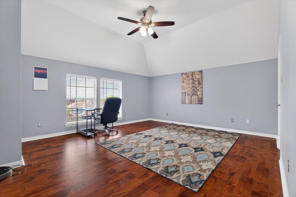 8708 Rugby Road Irving, TX 75063 - Photo 26 of 39 This versatile room features high vaulted ceilings, rich hardwood flooring, and bright windows with blinds
