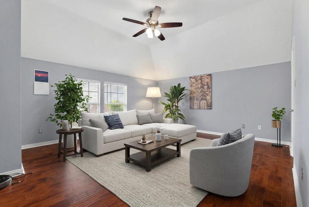 8708 Rugby Road Irving, TX 75063 - Photo 27 of 39 The living area features vaulted ceilings, rich hardwood flooring, and light blue walls