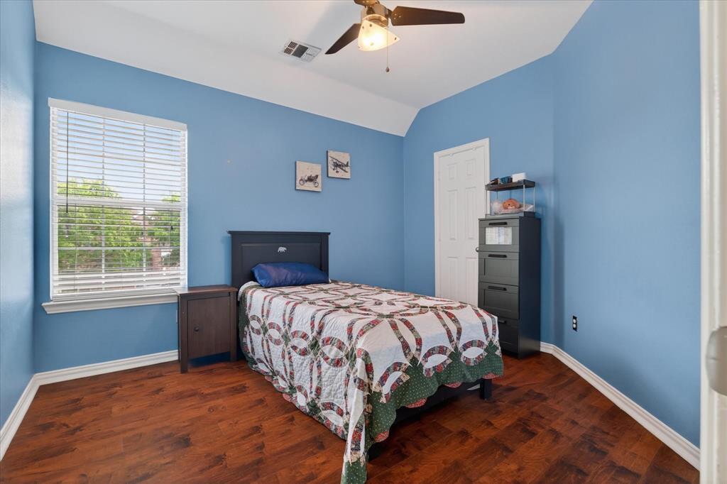 8708 Rugby Road Irving, TX 75063 - Photo 30 of 39 This room features rich wood flooring and light blue walls, complemented by a white ceiling and trim
