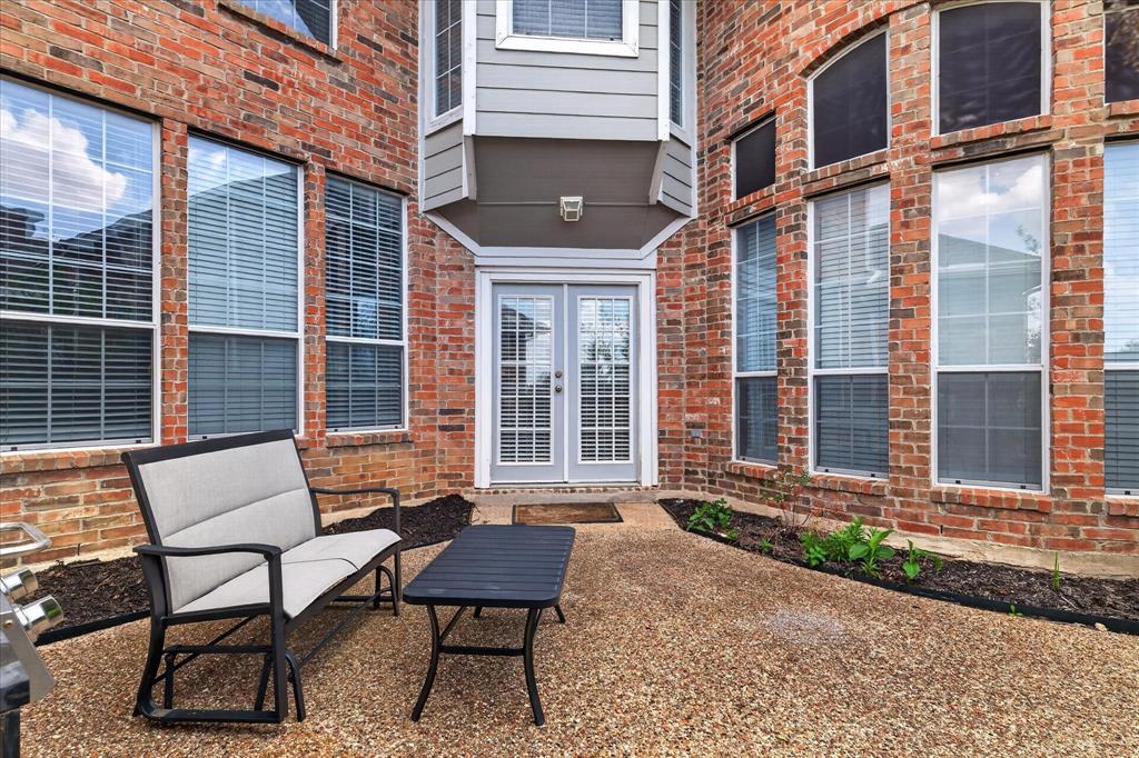 8708 Rugby Road Irving, TX 75063 - Photo 33 of 39 The property features a brick exterior with multiple windows and a gray double-door entry