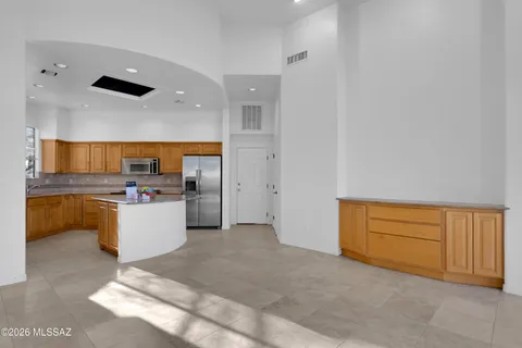 a view of a livingroom with wooden floor and a ceiling fan