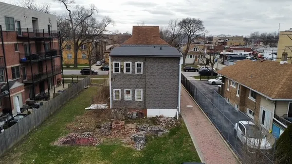 a view of a house with a backyard