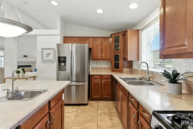 a kitchen with a sink stove top oven and cabinets