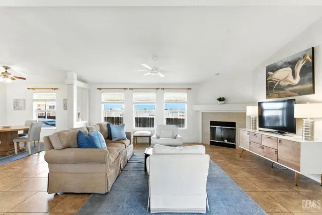 a living room with furniture a fireplace and a flat screen tv