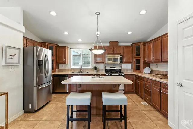 a kitchen with a sink stove and refrigerator