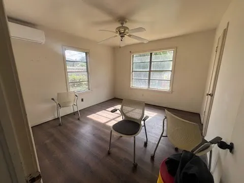 a view of a livingroom with furniture and a window