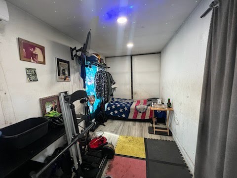 609 Firnat Street Houston, TX 77022 - Photo 8 of 10 a bedroom with furniture and a flat screen tv