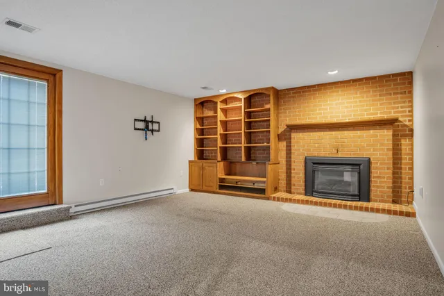 a view of an empty room with stairs and a window