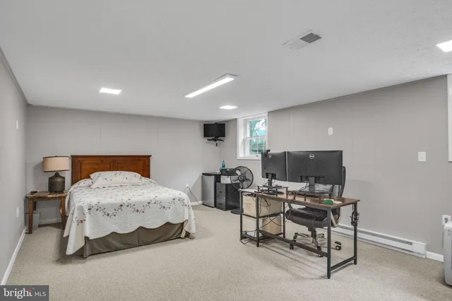 an empty room with kitchen and windows