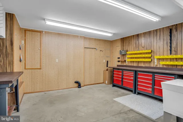 a view of an empty room with cabinet and a window