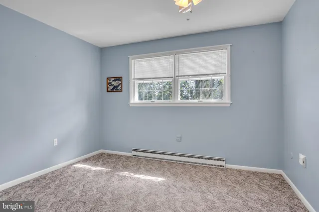 a spacious bathroom with a toilet a sink and a mirror