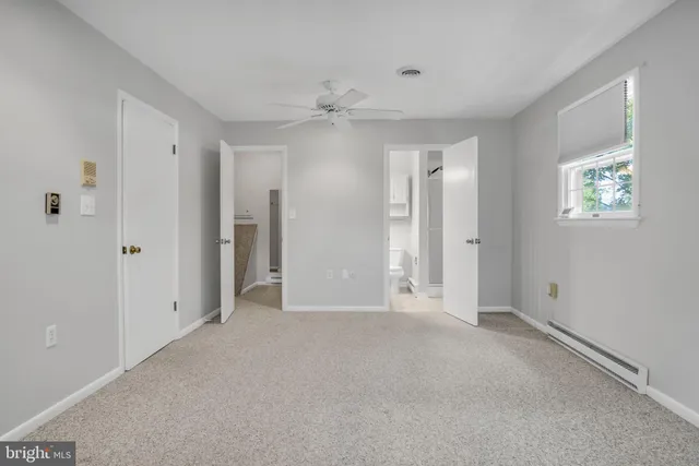 a view of a house with backyard and a tree