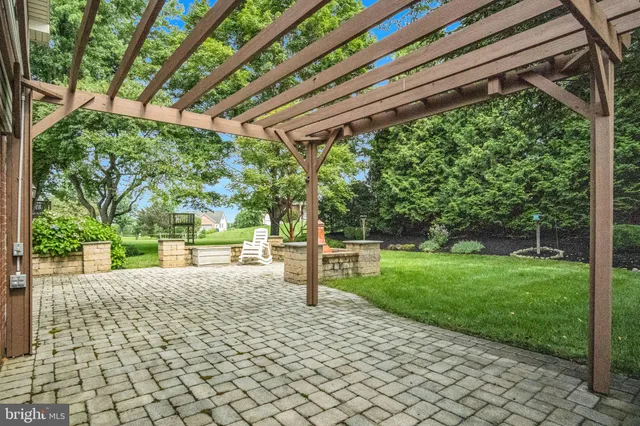 a view of a house with a big yard and large trees