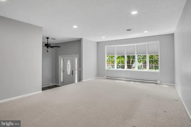 an empty room with windows and closet