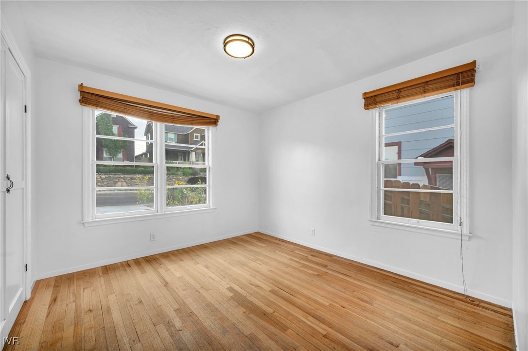 343 Mt Rose Street Reno, NV 89509 - Photo 21 of 46 an empty room with wooden floor and windows