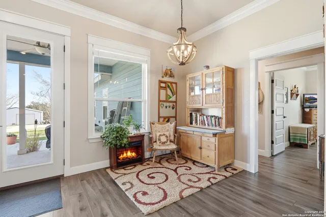 a view of a dining room with furniture wooden floor and chandelier