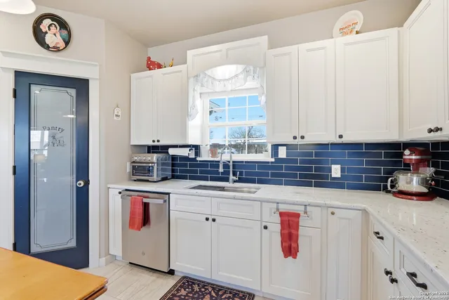 a kitchen with stainless steel appliances a refrigerator sink and cabinets