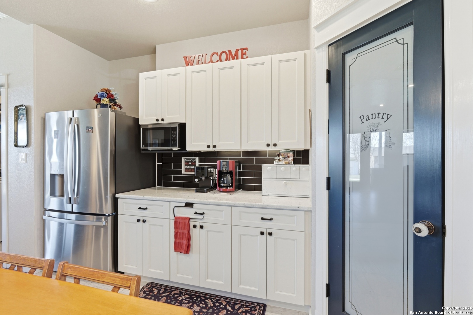 682 Stuart Road Adkins, TX 78101 - Photo 17 of 37 a kitchen with stainless steel appliances a refrigerator sink and cabinets