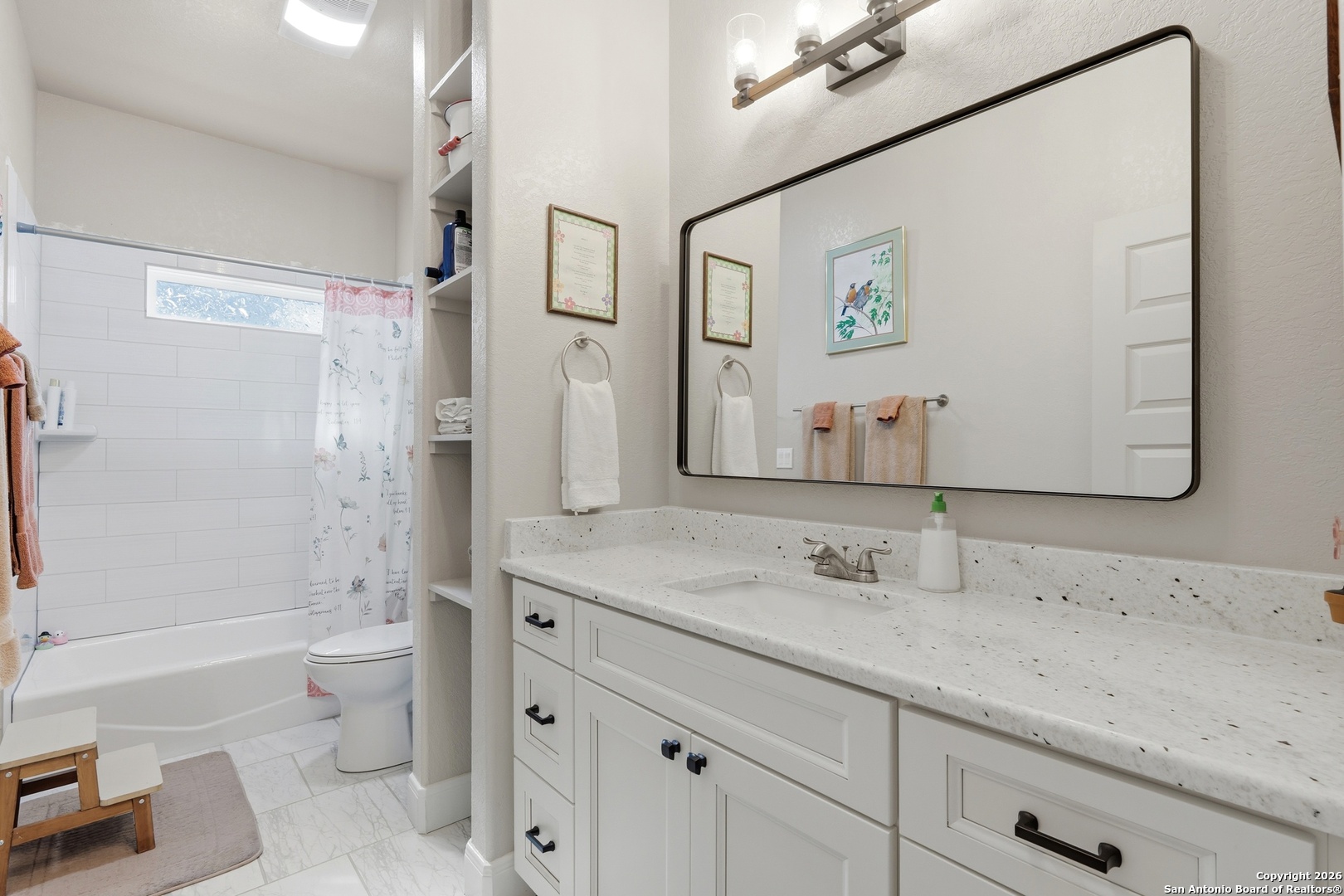 682 Stuart Road Adkins, TX 78101 - Photo 19 of 37 a bathroom with a granite countertop sink toilet and shower