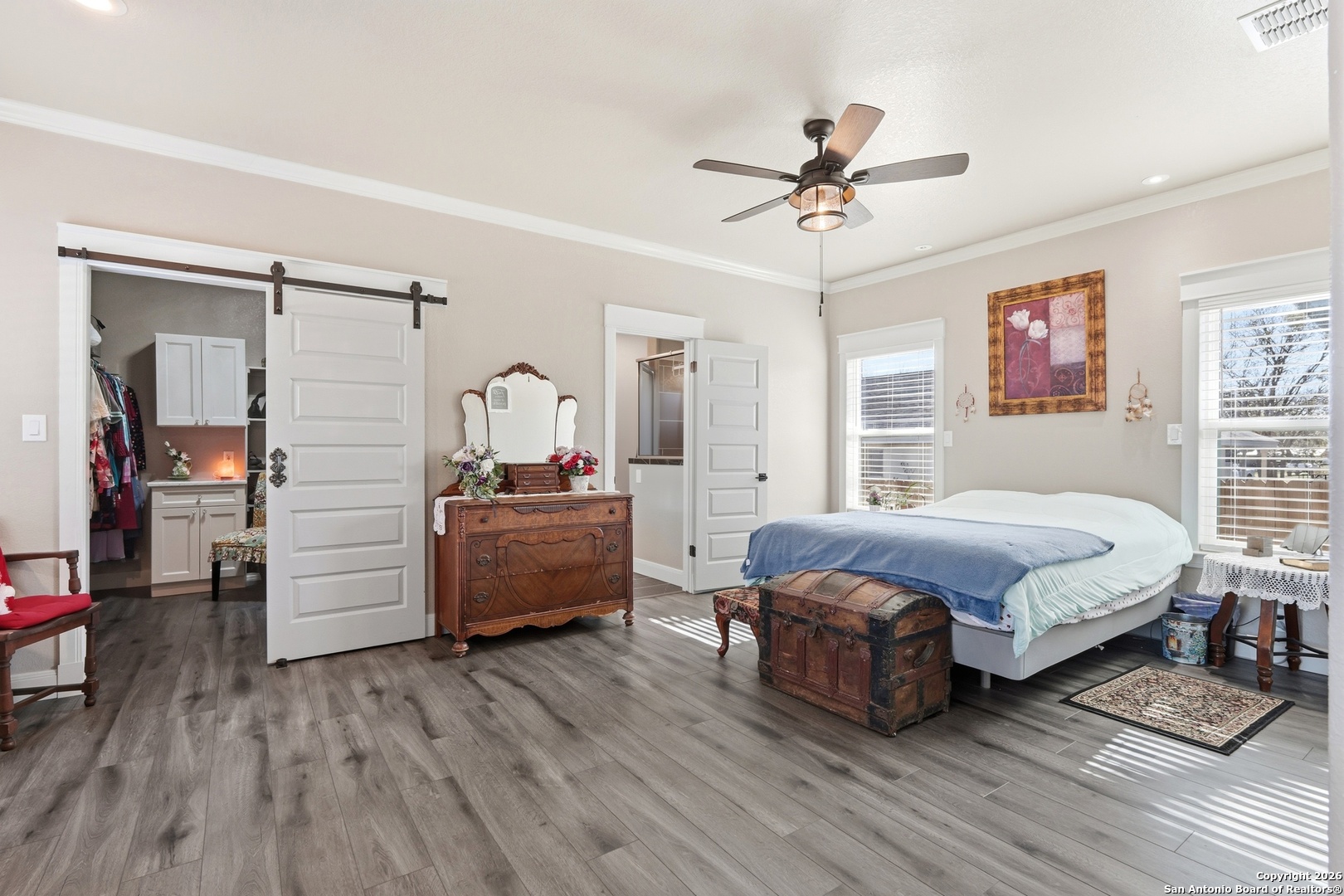 682 Stuart Road Adkins, TX 78101 - Photo 22 of 37 a spacious bedroom with a bed and wooden floor