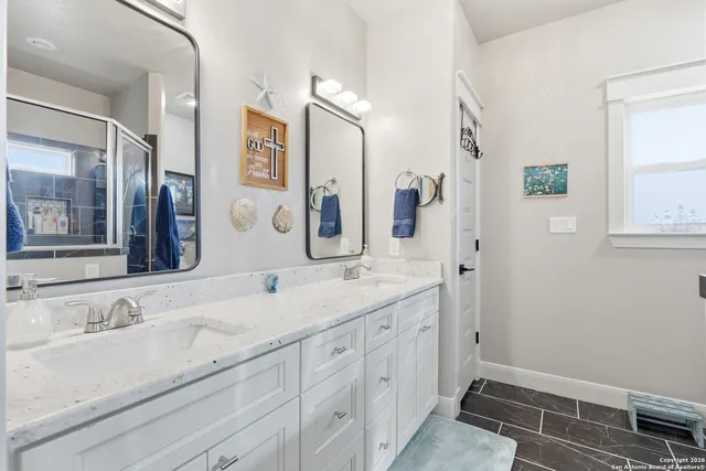 a bathroom with a toilet a sink and a mirror