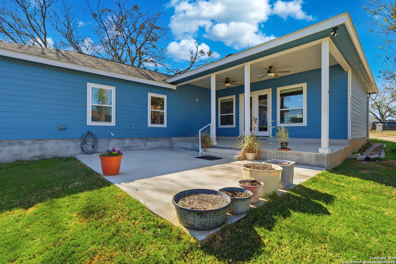 682 Stuart Road Adkins, TX 78101 - Photo 27 of 37 a view of a backyard with table and chairs potted plants and a barbeque
