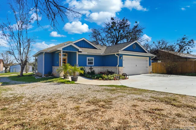 a front view of a house with a garden