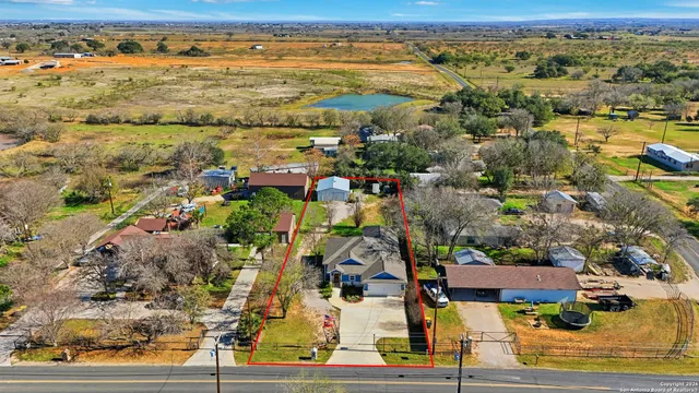 an aerial view of residential houses with outdoor space