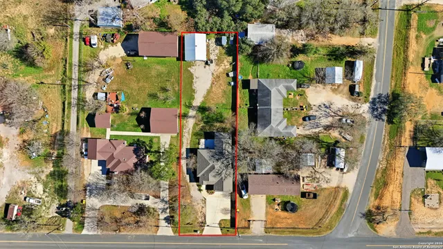 an aerial view of a house with a yard