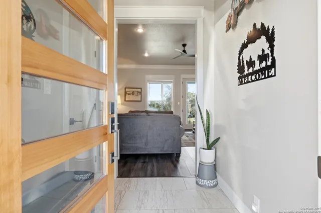 a view of living room kitchen and entryway