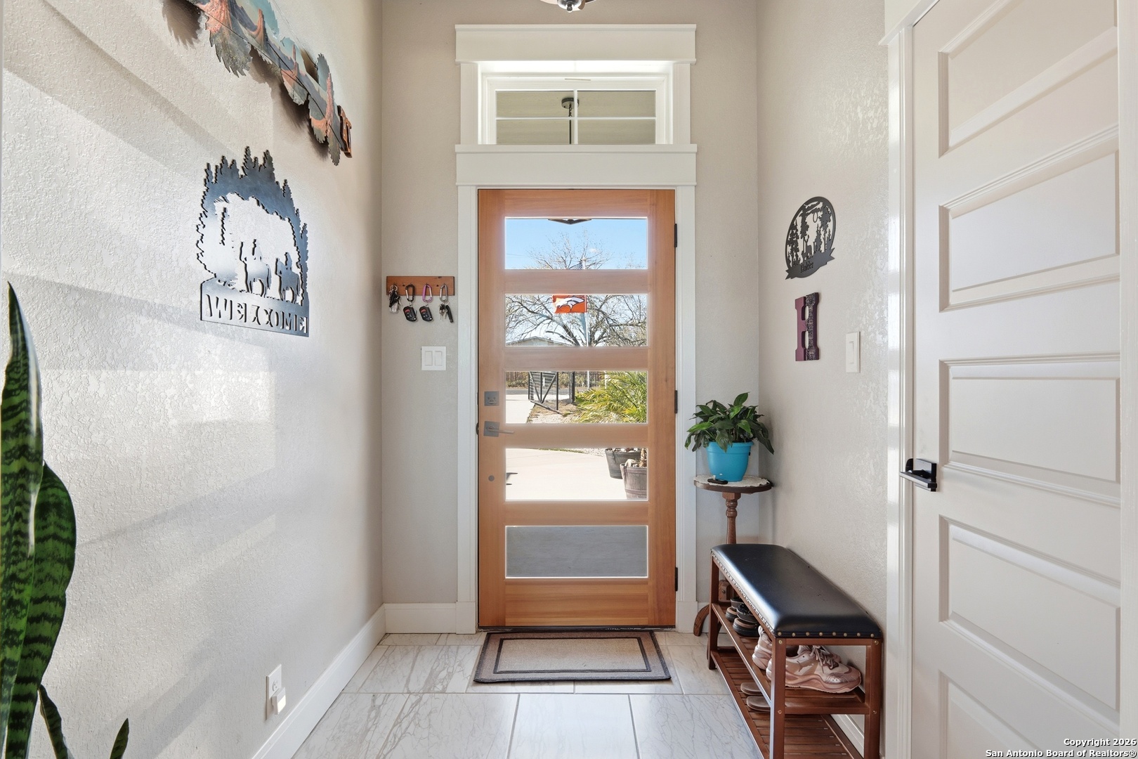 682 Stuart Road Adkins, TX 78101 - Photo 8 of 37 a hallway with painting on the wall