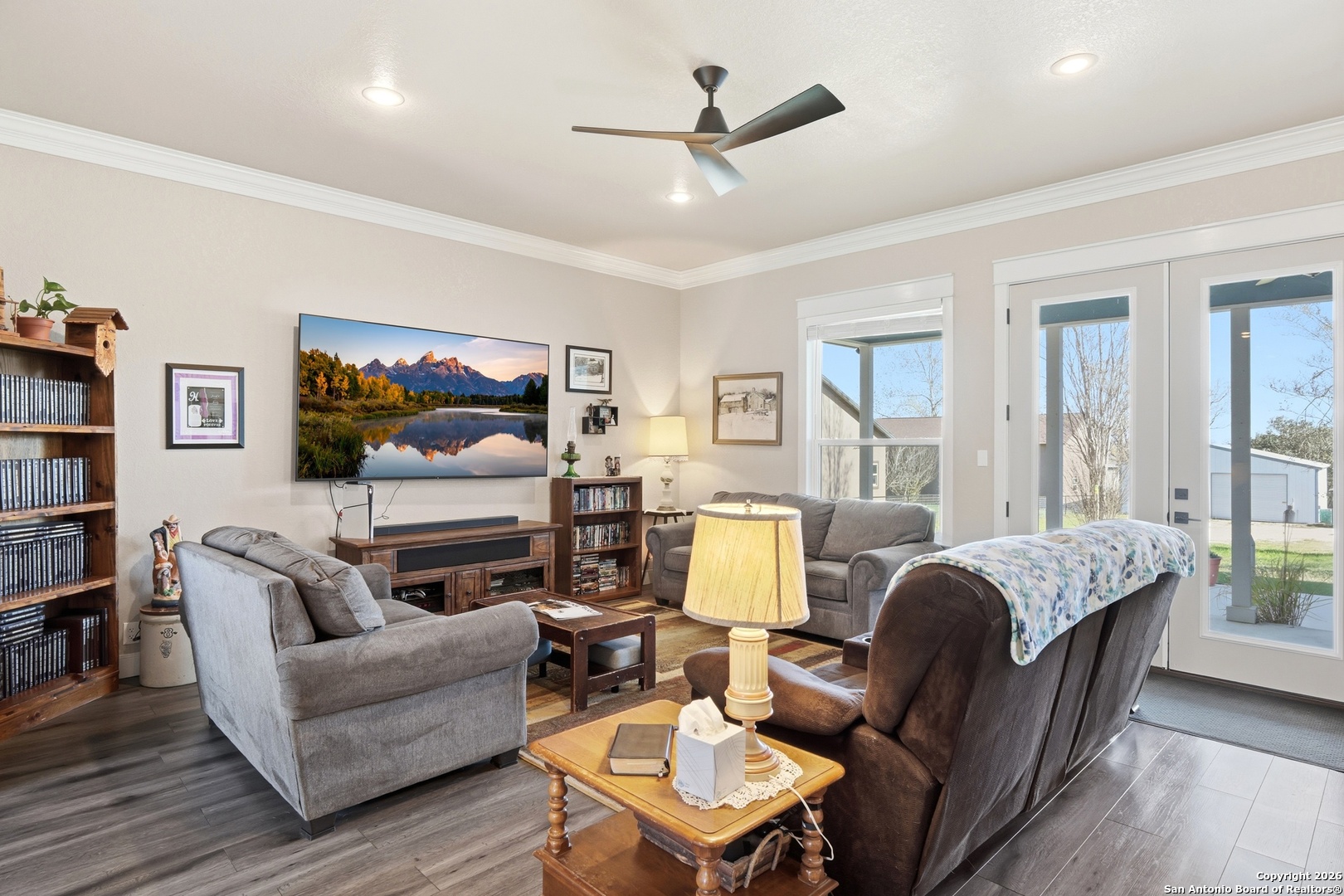 682 Stuart Road Adkins, TX 78101 - Photo 10 of 37 a living room with furniture ceiling fan and a wooden floor
