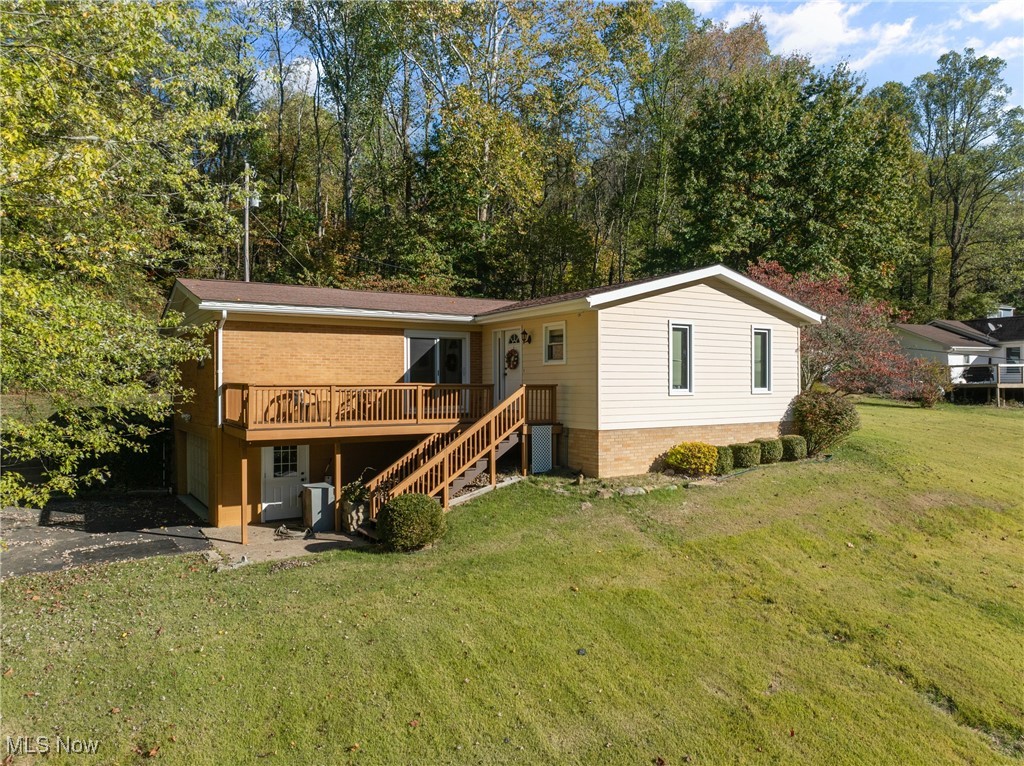 59638 Broadview Road Shadyside, OH 43947 - Photo 1 of 43 Back of property featuring a lawn, a wooden deck, stairs, and asphalt driveway