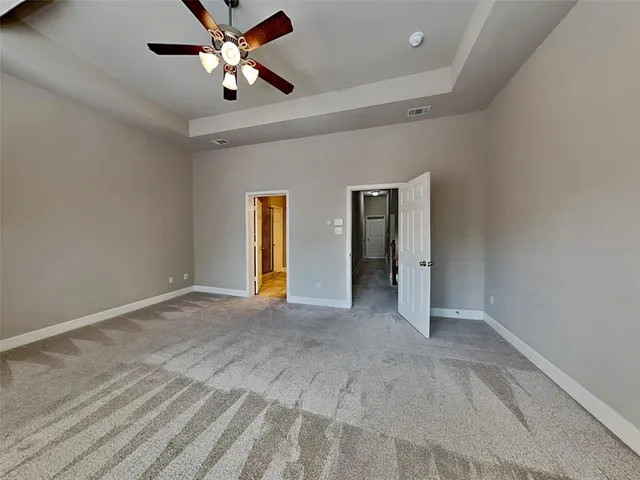 a view of an empty room with a ceiling fan