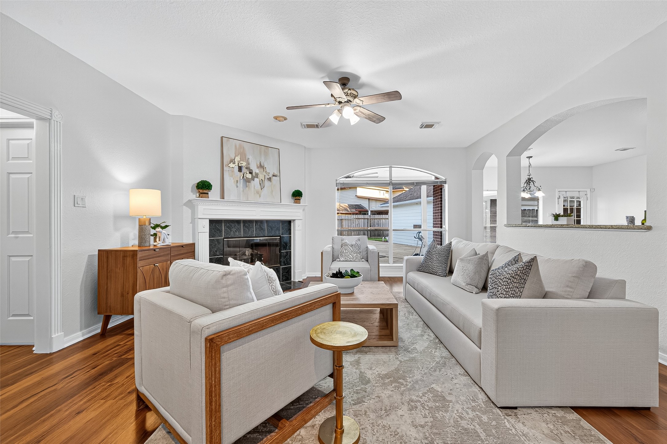 13011 Mossy Ridge Cove Houston, TX 77041 - Photo 12 of 50 a living room with furniture a fireplace and a large mirror