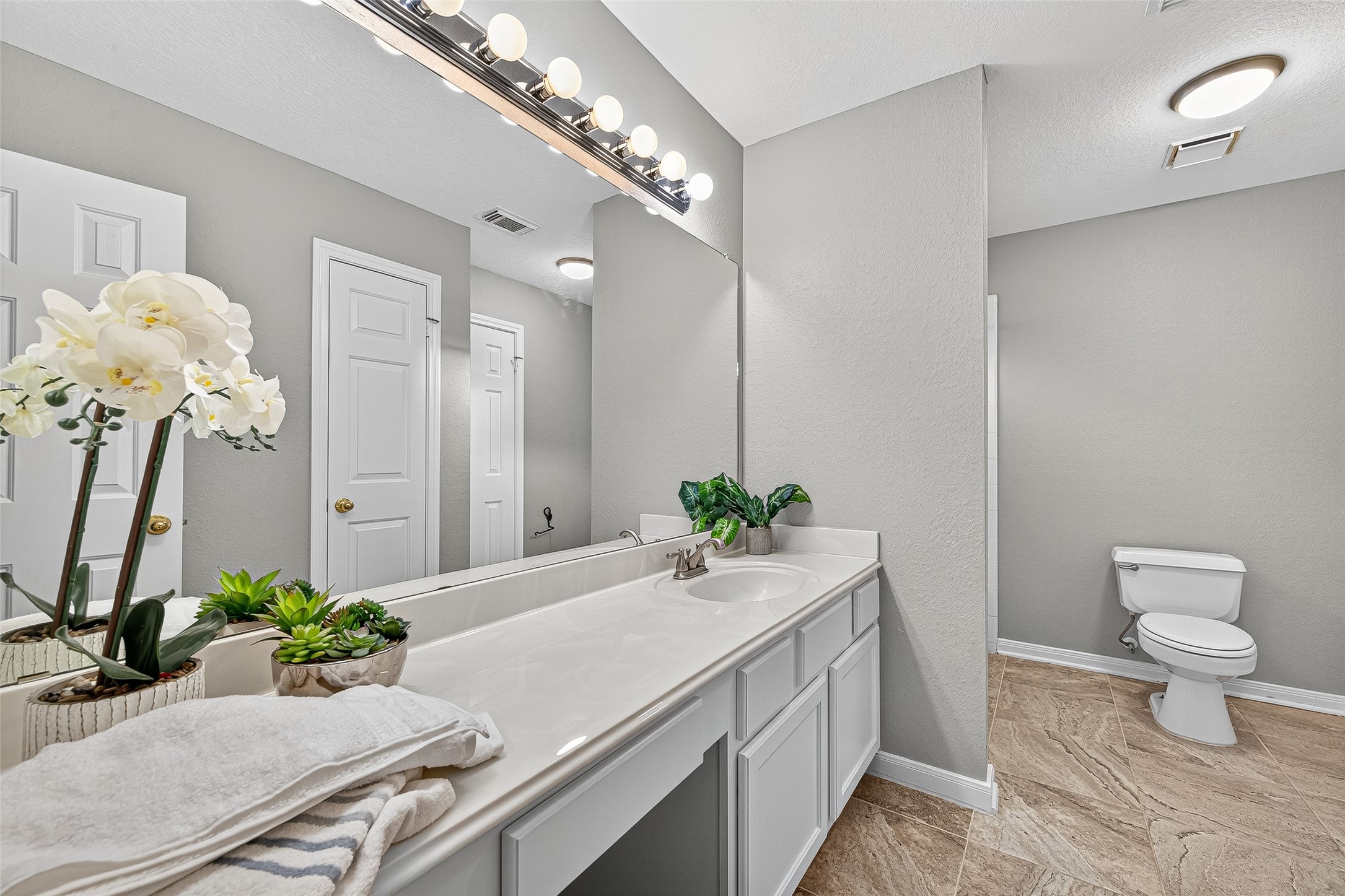 13011 Mossy Ridge Cove Houston, TX 77041 - Photo 38 of 50 a bathroom with a sink a toilet and mirror