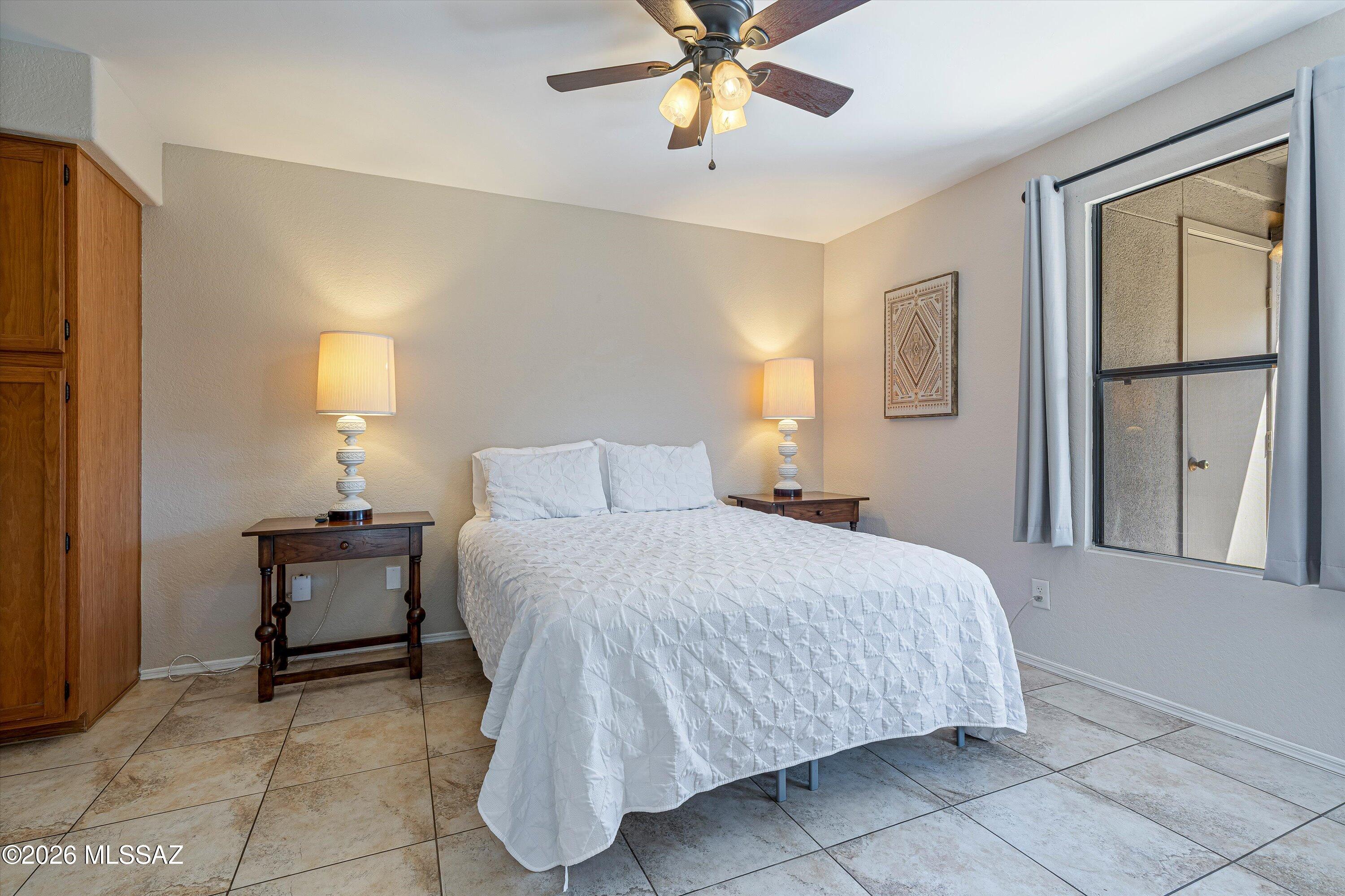 5800 North Kolb Road, Unit 5125 Tucson, AZ 85750 - Photo 12 of 34 a bedroom with a bed and a chandelier