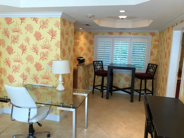 a view of a dining room with furniture and a window