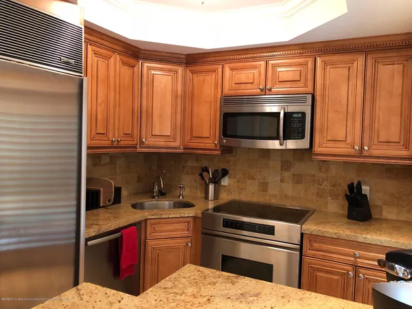 a kitchen with stainless steel appliances granite countertop a sink and cabinets